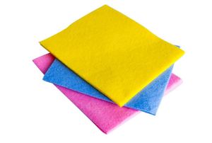 A stack of cloths in pink, blue, and yellow.