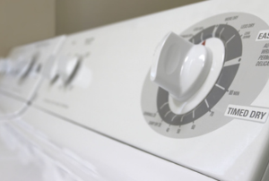Top of a white clothes dryer showing the timer knob