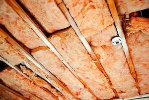 Pink, fiberglass insulation in an unfinished roof.