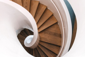 wooden spiral staircase with beautiful curved railing