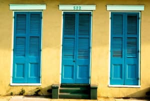 Three blue, louvered, exterior doors.
