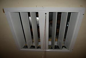 A whole house fan installed in a home's ceiling.