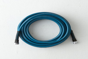 A dark blue garden hose coiled up