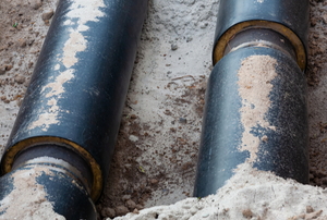 insulated gas pipes in a dirt trench