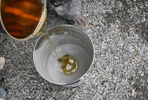 mixing epoxy in a bucket