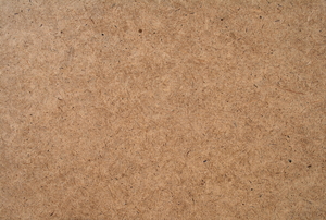 A close-up of the textured surface of a hardboard piece.