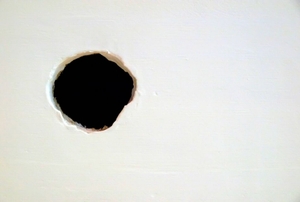A hole in a white wall.