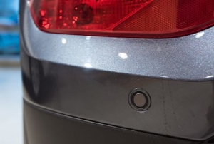 back of car with parking sensor on bumper