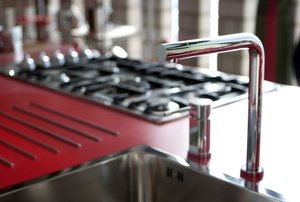 A sleek modern sink and counter top with a silver faucet and air cap cap.