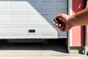 A man uses a garage door opener.