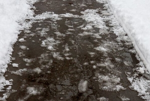 An iced-over walkway outside a home.