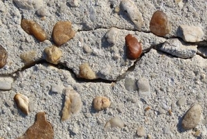 cracked concrete with stones mixed in