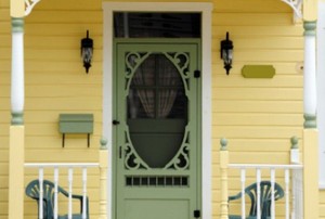 porch of yellow house with screen outside front door