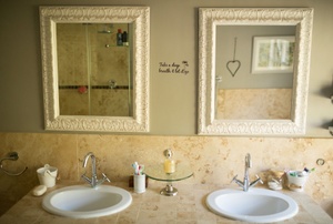 A bathroom with two mirrors.