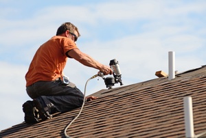 man working on a roof