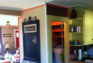 A closet oddly separating a living room and kitchen.