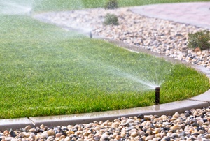 Sprinkler spraying a well-manicured lawn
