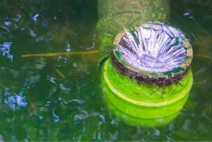 a pipe draining water from a pond