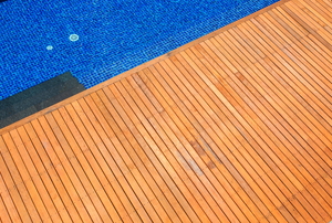 A pool deck made from teak wood.