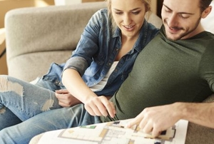 couple planning home improvement with blueprint