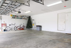 large garage with shelving and bikes in one corner