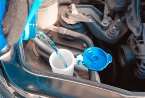 fluid filling a windshield washer reservoir