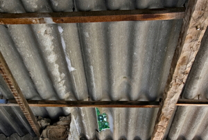 A worn sheet of corrugate metal roofing.