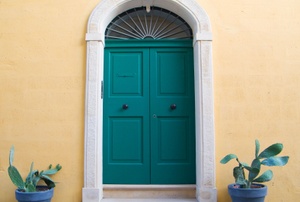 A green door with a marble threshold.