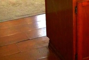 A laminate floor with the layers peeling up.