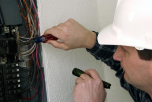 man working on an electrical box
