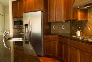 Kitchen with dark cabinets and stainless steel appliances.