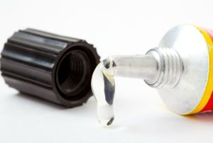 glue seeping out of a tube with cap next to it