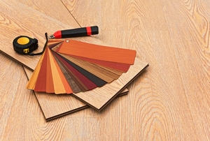 array of laminate faux-wood flooring options, boards, and tools