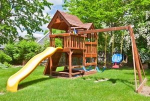 Backyard play structure with slide and swings