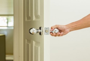 Person opening the door into a room