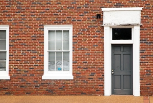 brick building with windows and exterior black door