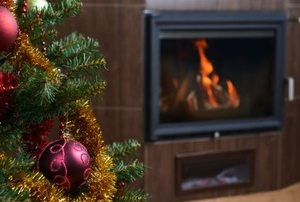 A Christmas tree and fireplace.