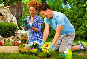 A young, cheerful couple planting flowers
