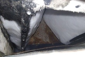 an ac unit with icy build-up