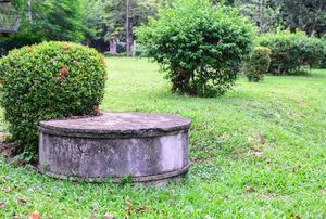 A septic tank in a yard.