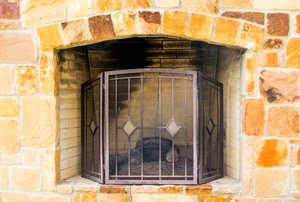 Brick fireplace with metal screen