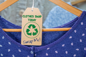 blue shirt hanging with a recycle tag that says "clothes swap today, swap me"