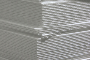 Stack of white foam-core panels.