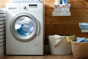 a neat laundry room with a washing machine