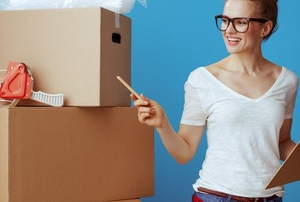 woman with boxes and clipboard preparing for a move