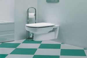 Bathroom with wall mount toilet and green and white checkered flooring