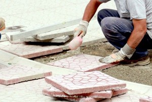 person installing rubber pavers