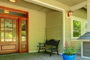 a wood colored fiberglass door on a front porch