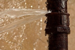 Water spraying from a cast iron pipe