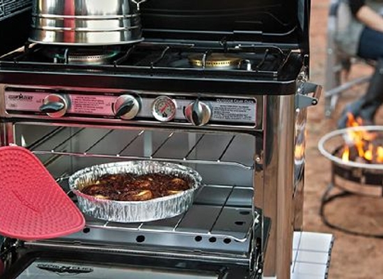 hand with heat protector using outdoor camping oven